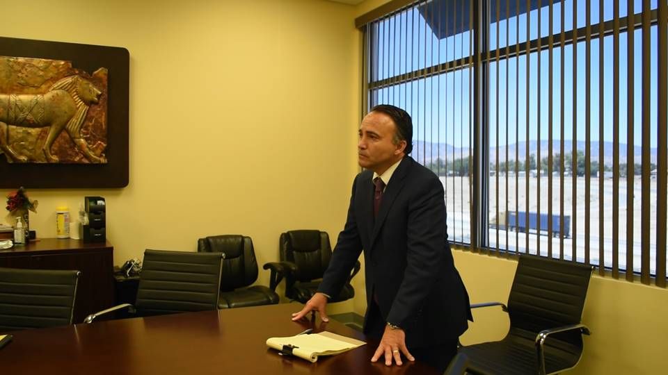 Attorney Angelo F. Campano at the conference table in his Palmdale office